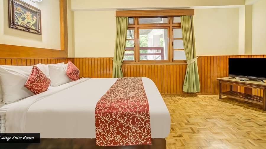 Side view of a room with bed and a television in front at Summit Tashi Ghang Heritage Resort, Pelling