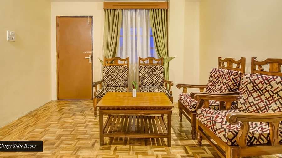 Image of a room with chiars and wooden table at Summit Tashi Ghang Heritage Resort, Pelling