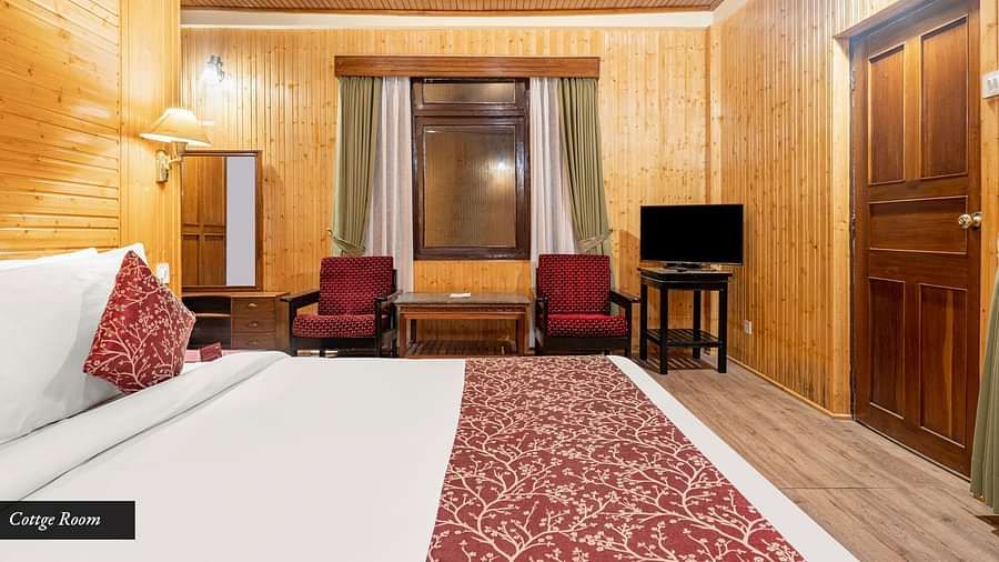 Side view of a room with bed and television in the corner at at Summit Tashi Ghang Heritage Resort, Pelling