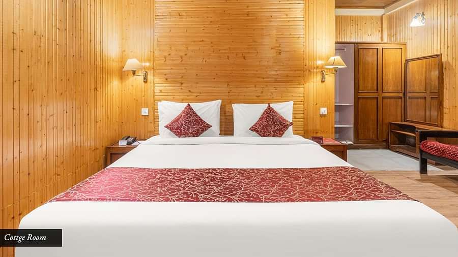 Image of a room with wooden decor and a double bed at at Summit Tashi Ghang Heritage Resort, Pelling