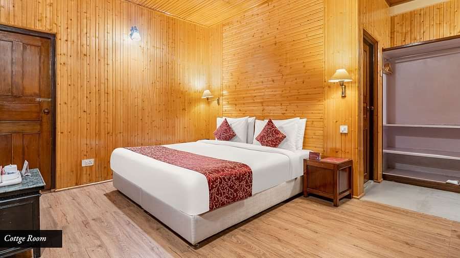 Image of  a room with bed and lamps mounted above the bed at Summit Tashi Ghang Heritage Resort, Pelling