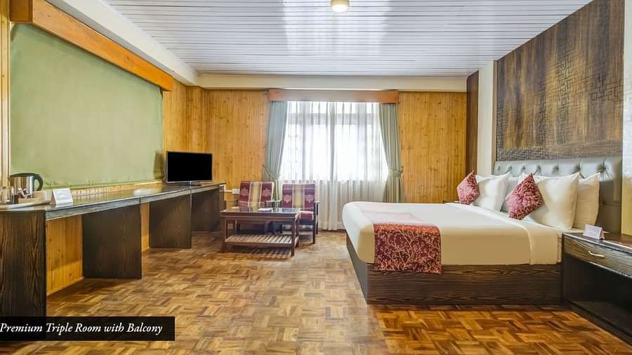 Image of a room with bed and a large table at Summit Tashi Ghang Heritage Resort, Pelling