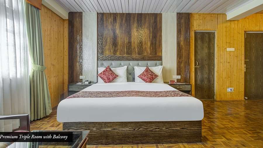 Image of a room with a large bed and widows on the side of the room at Summit Tashi Ghang Heritage Resort, Pelling