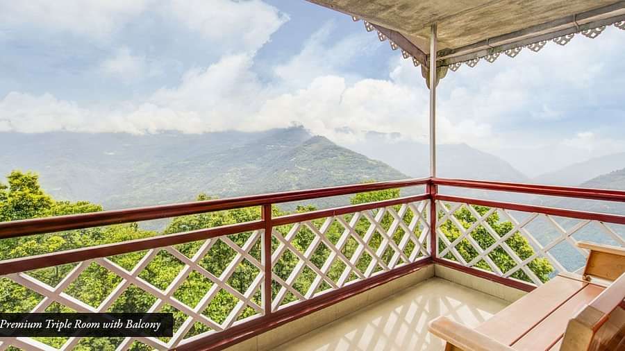 Image of a balcony with sitting area and view of the mountians at Summit Tashi Ghang Heritage Resort, Pelling