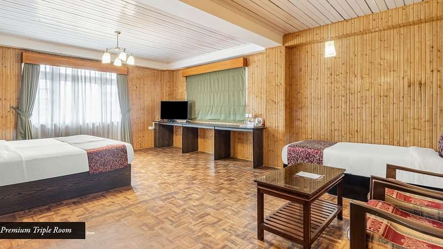 Image of a room with two beds and sitting area at Summit Tashi Ghang Heritage Resort, Pelling