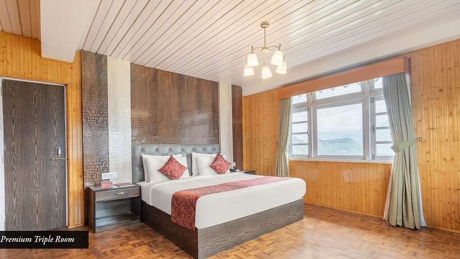 Image of a room with bed and a chandelier hanging from the wall at Summit Tashi Ghang Heritage Resort, Pelling
