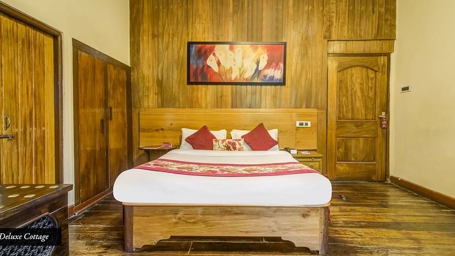 Deluxe cottage at Summit Barsana Resort & Spa, Kalimpong with a double bed