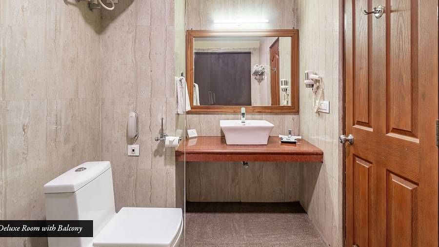 Washroom area of the deluxe room at Summit Barsana Resort & Spa, Kalimpong with a vanity