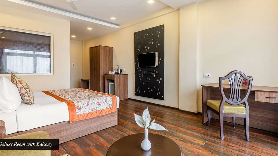 Deluxe room at Summit Barsana Resort & Spa, Kalimpong with a double bed