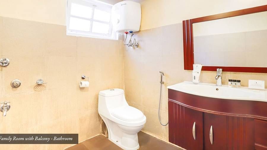 A commode in a bathroom that has a wash basin and a mirror on the wall | Summit Newa Regency & Spa, Pelling