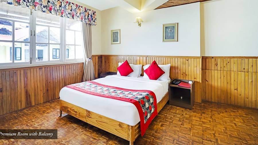 A bed placed in a room with a glass window | Summit Newa Regency & Spa, Pelling