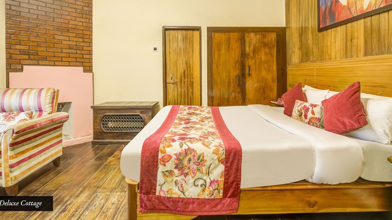 Deluxe cottage at Summit Barsana Resort & Spa, Kalimpong with a double bed and a wardrobe