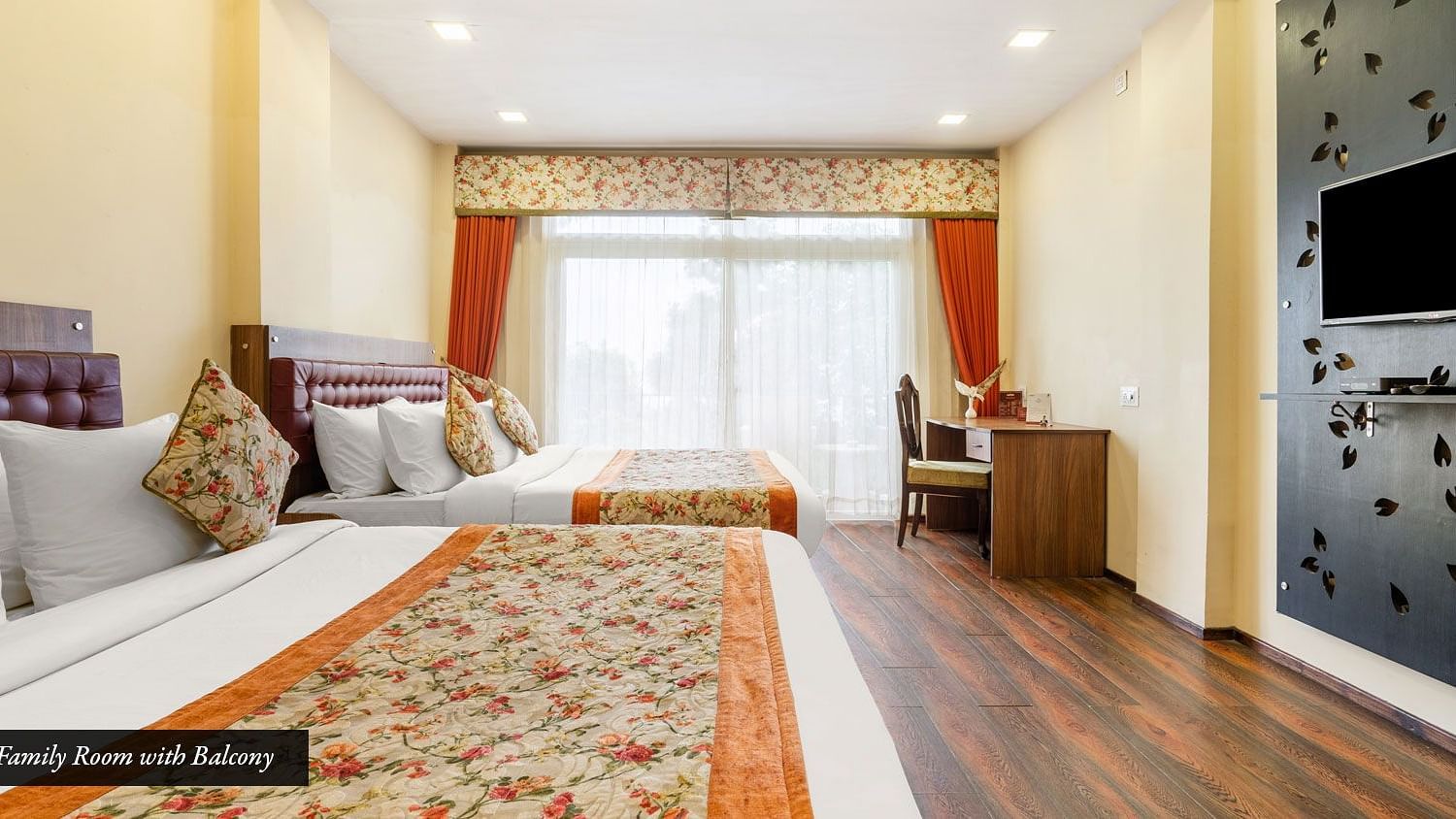 Family room at Summit Barsana Resort & Spa, Kalimpong with a double bed, a television and large windows