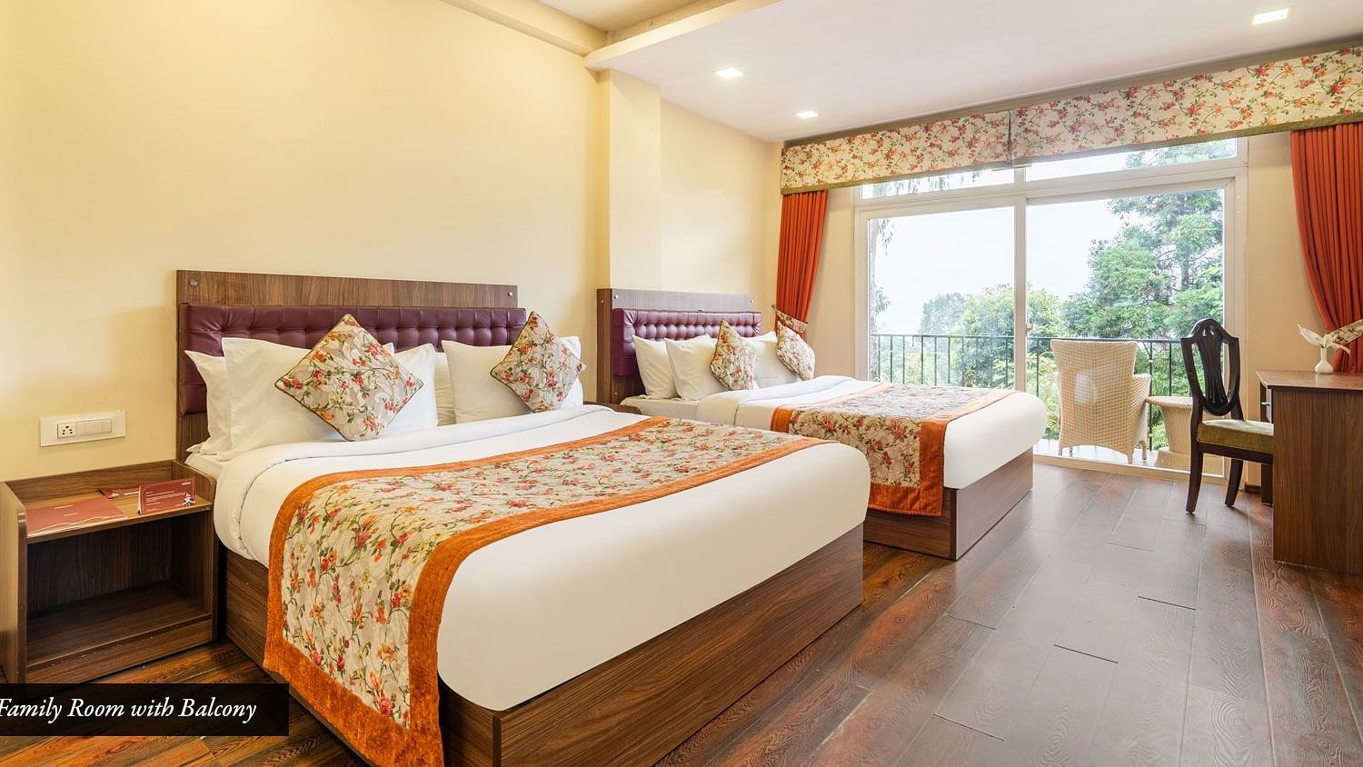 A room with twin beds and a balcony at Summit Barsana Resort & Spa, Kalimpong