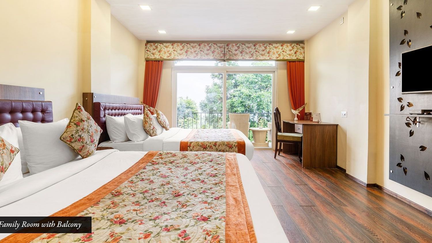 A room with twin beds and a balcony at Summit Barsana Resort & Spa, Kalimpong