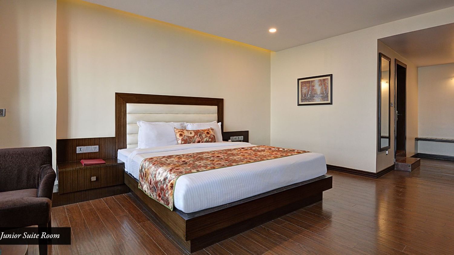 Junior Suite View Room with spacious bed, sofas, bed side table