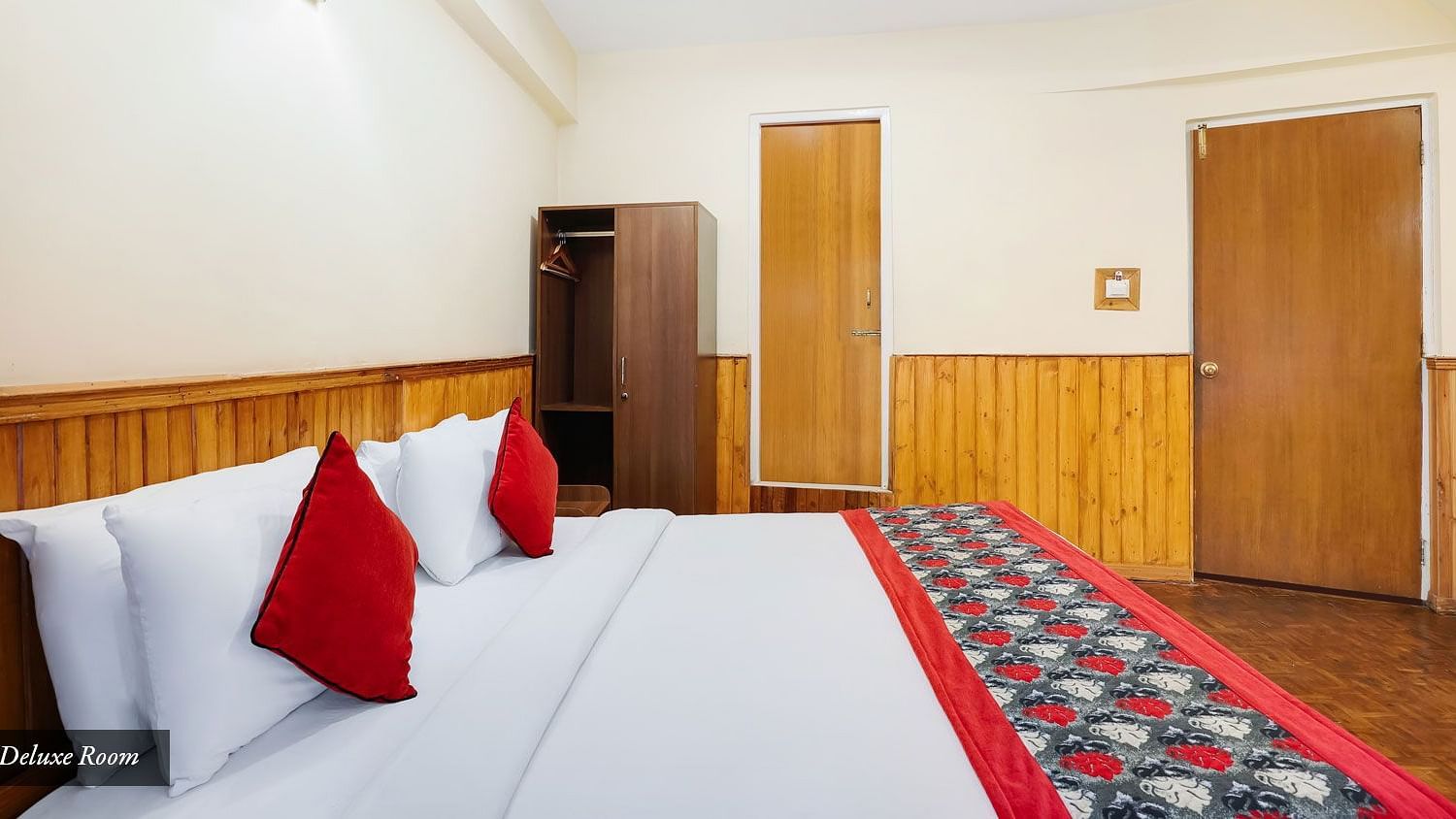 A side view of a bed in a room that has a wardrobe | Summit Newa Regency & Spa, Pelling
