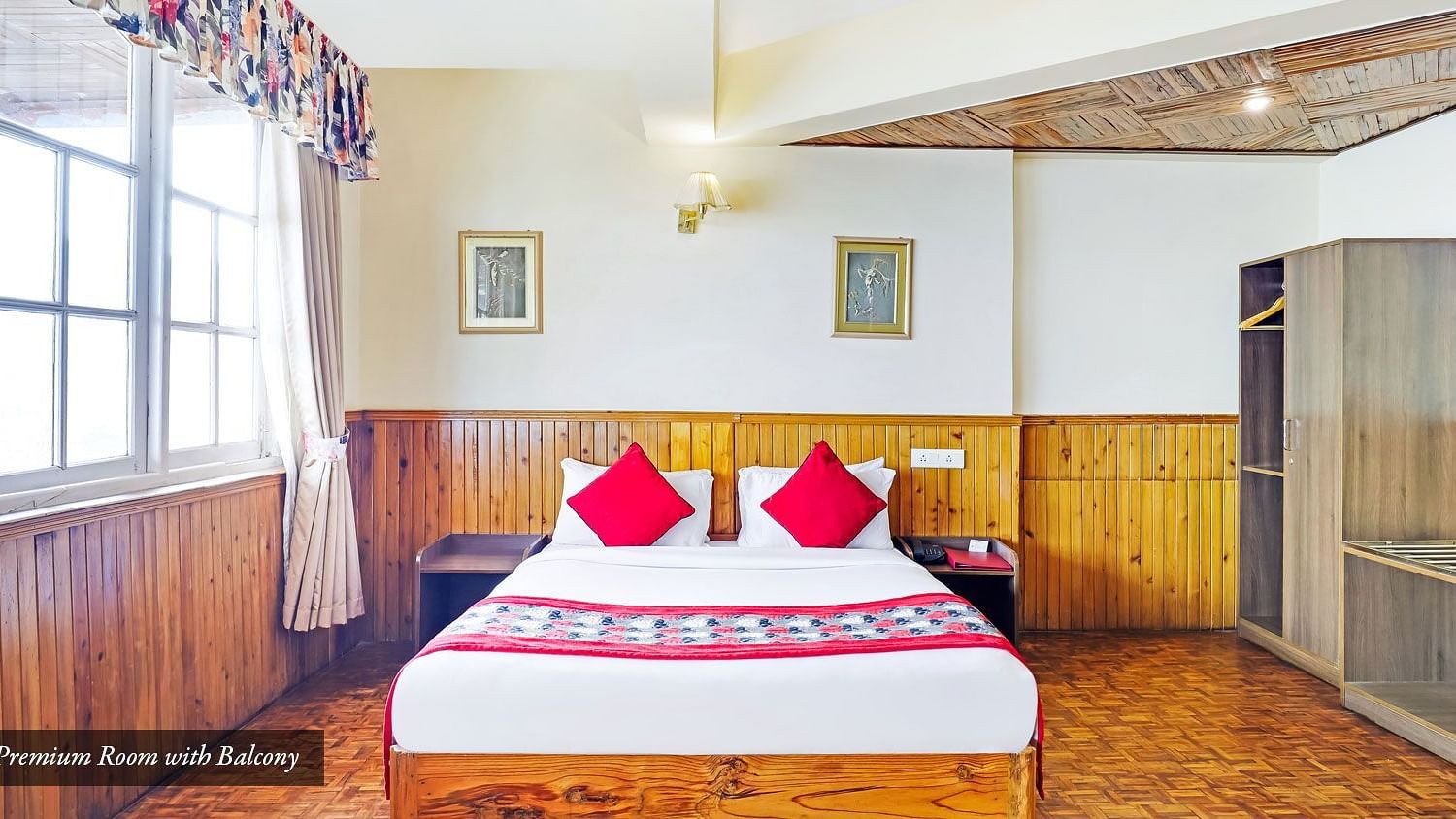 A front view of bed in a room with a glass windows | Summit Newa Regency & Spa, Pelling