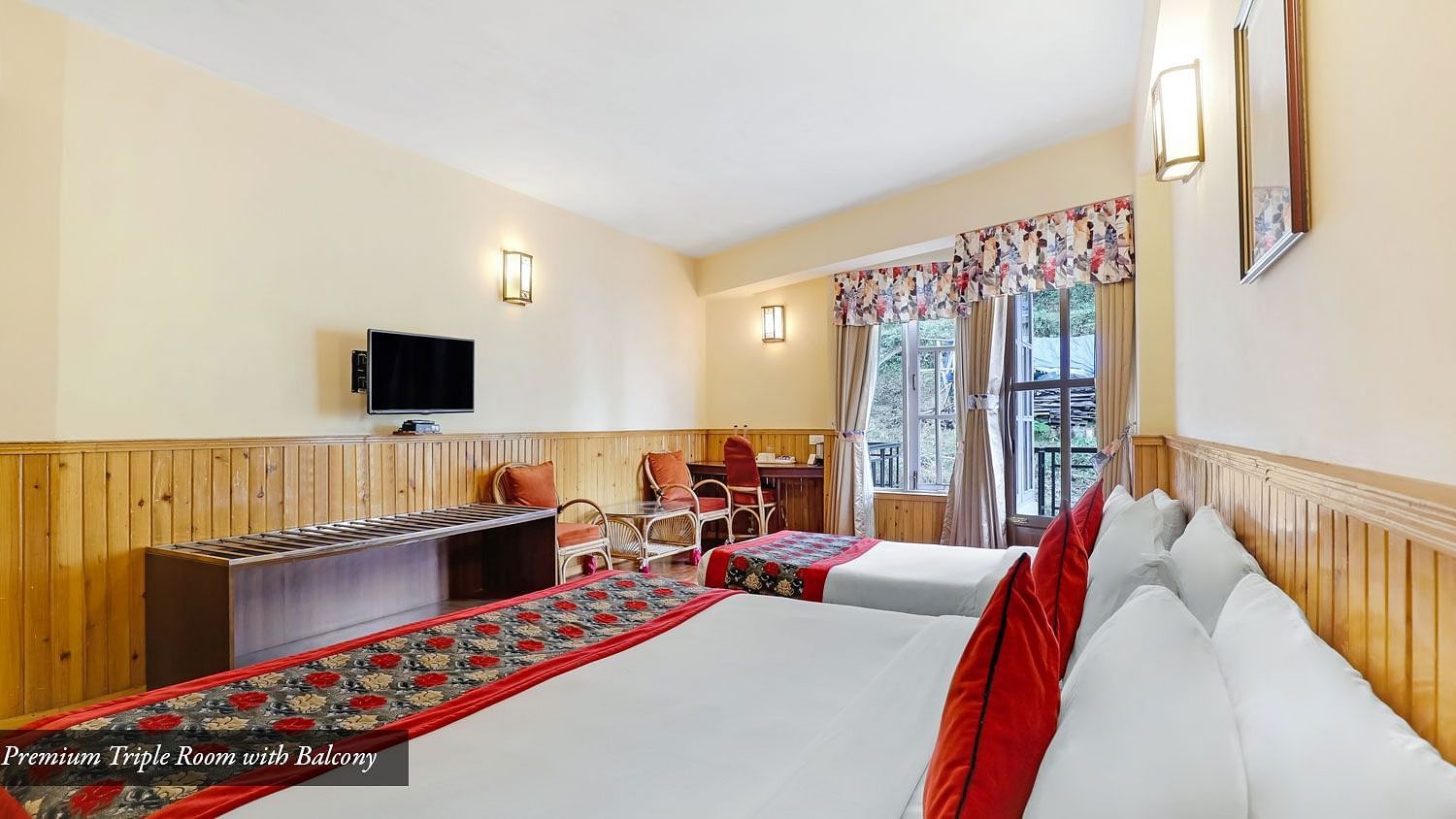 A side view of beds placed in a room that has a window and a TV on the wall | Summit Newa Regency & Spa, Pelling