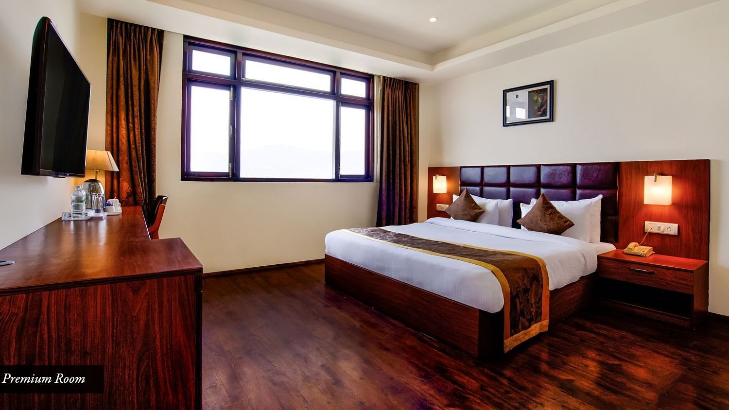 Premium Room with spacious bed, wall mounted television opposite to the bed at Summit Ttakshang Residency Hotel & Spa, Gangtok