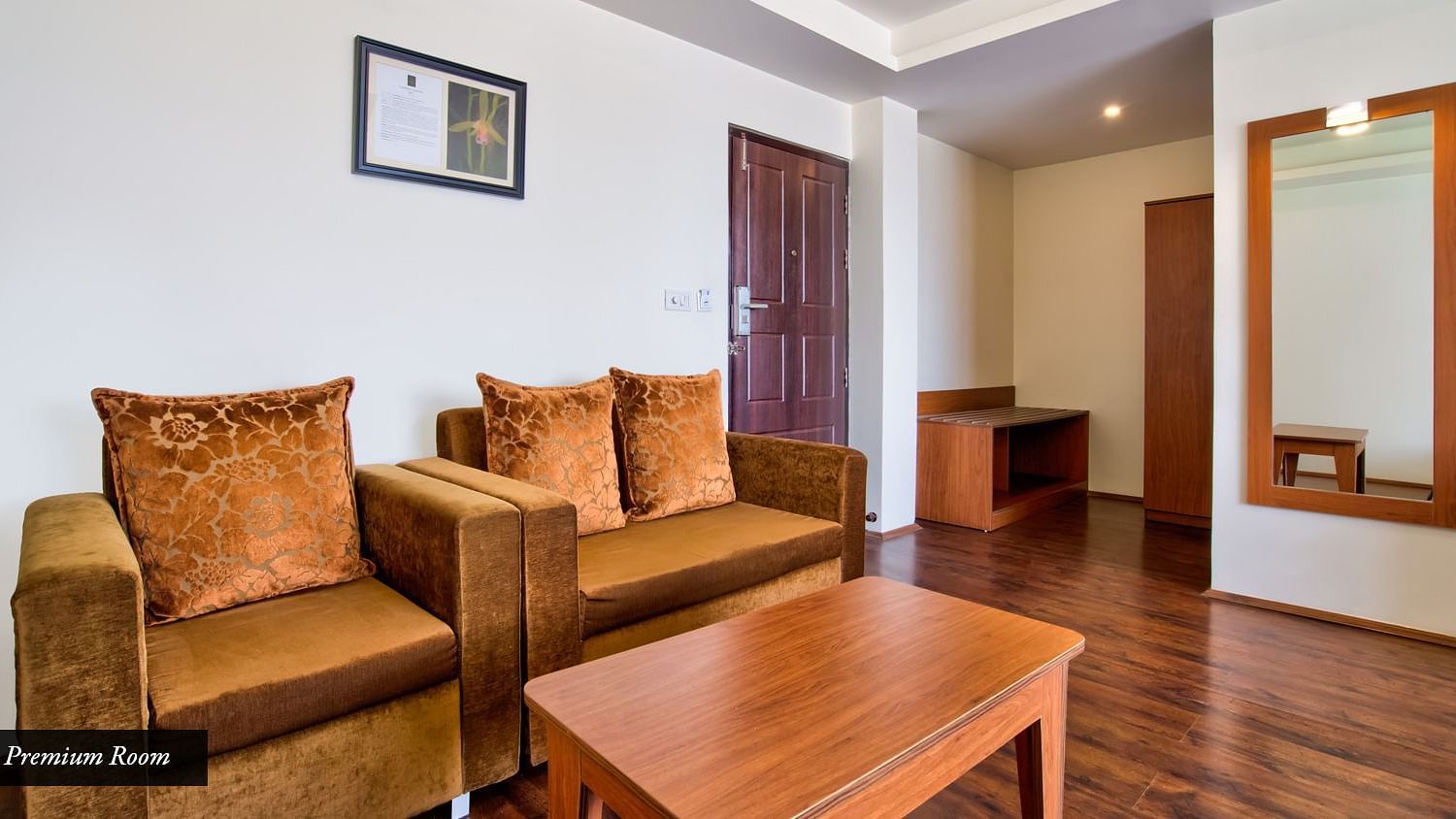 Premium Room with cushion furniture along with wooden table placed in front of the seating at Summit Ttakshang Residency Hotel & Spa, Gangtok