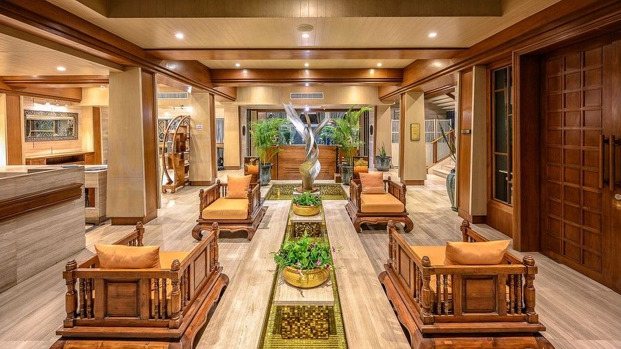 image of the lobby with traditional wooden seats for the guests - Maikhao Dream Villa Resort & Spa, Phuket