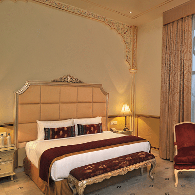 Image of a room with a bed and a chair on the side at Rajasthali Resort & Spa Jaipur.