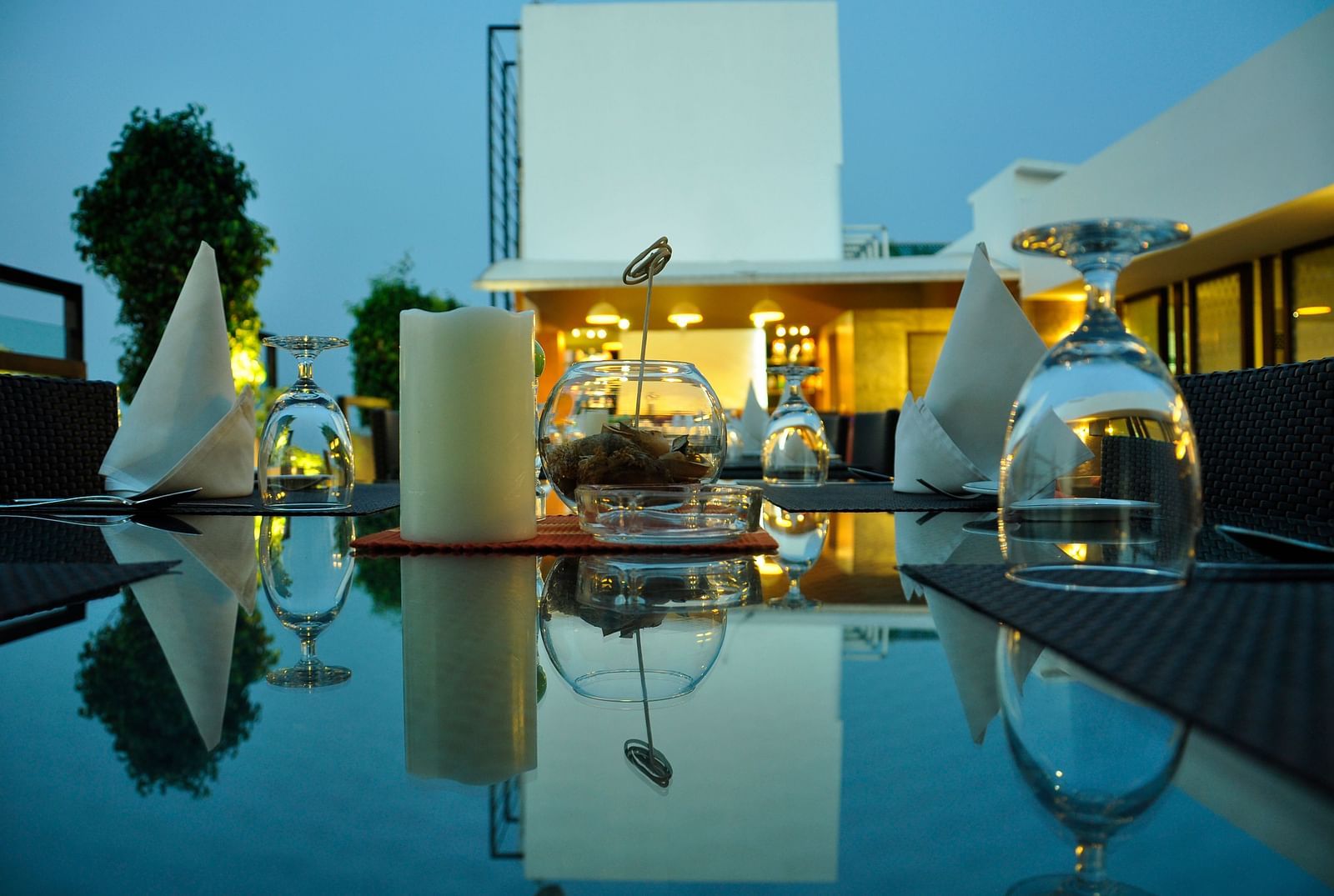 candles, napkins and glass kept on a table at Hotel Atithi - TGI Grand, Pondicherry