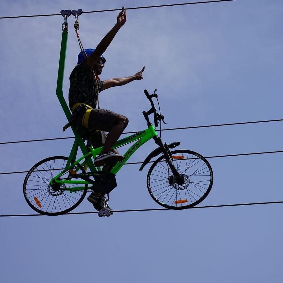 A person rope cycling with intact safety measures at GK Hill View Resort.
