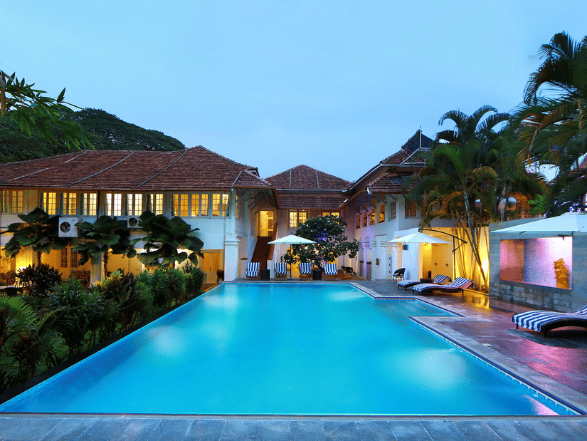 The Tower House in Fort Kochi featuring a pool with clear blue water captured during dusk