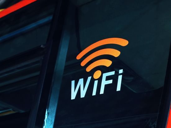 A wi-fi symbol with the words wifi on a bus placed on a plastic exterior