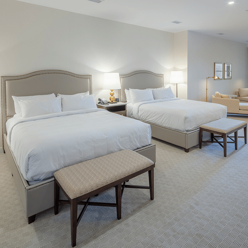 Lakeview Double King Room featuring two large beds under warm lighting and a seating space by large windows at YO1 Longevity & Health Resorts
