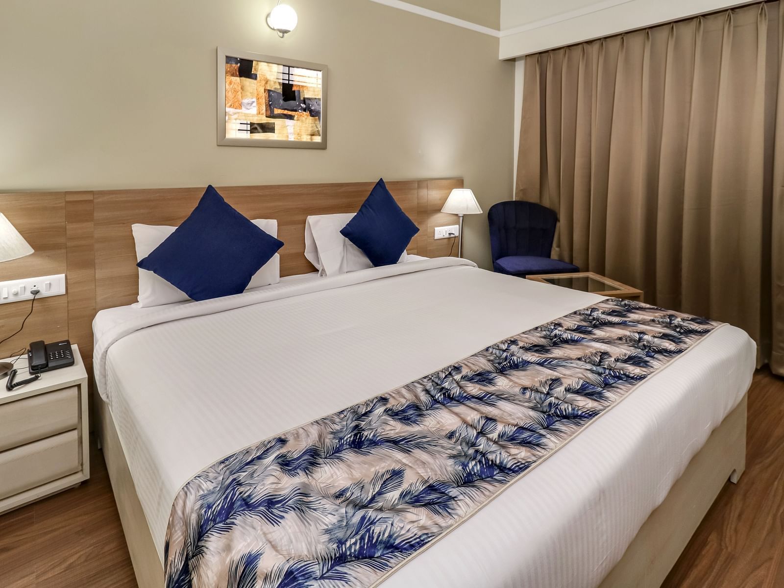 A double bed with side tables inside Deluxe Suite - Starlit Suites Newtown, Kolkata