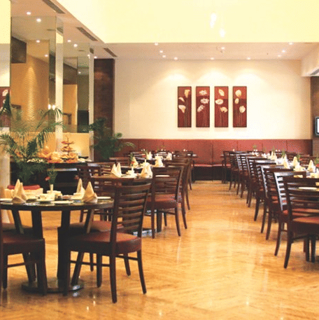 A dining area with tables, chairs and ambient lights.