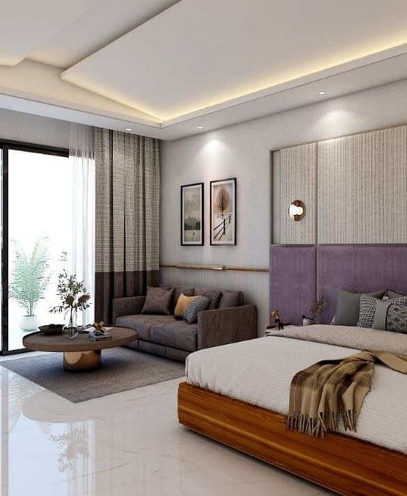A beautiful room with ample of natural light coming from the huge french windows featuring a double bed in the room. - Namaste Corbett
