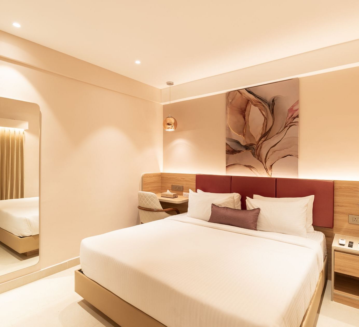 King-sized bed with elegant decor in The Premium Rooms at Livancia The Sojourn, Bangalore.