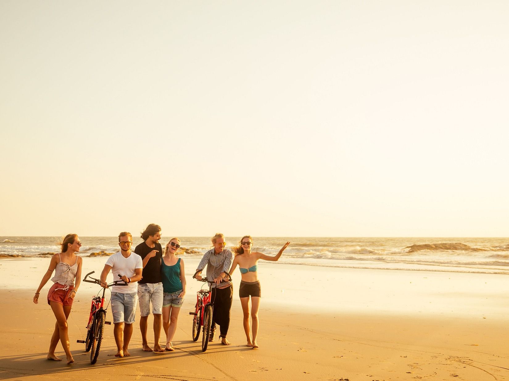 A group of people enjoying the outdoors on the beach.