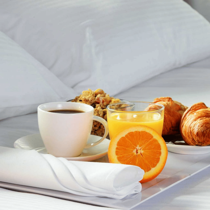 A close up of a tray containing many breakfast items placed on a bed - Ramada by Wyndham Addis, Addis Ababa.