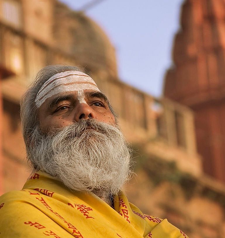 An close-up image of a man with a blurred building in the background