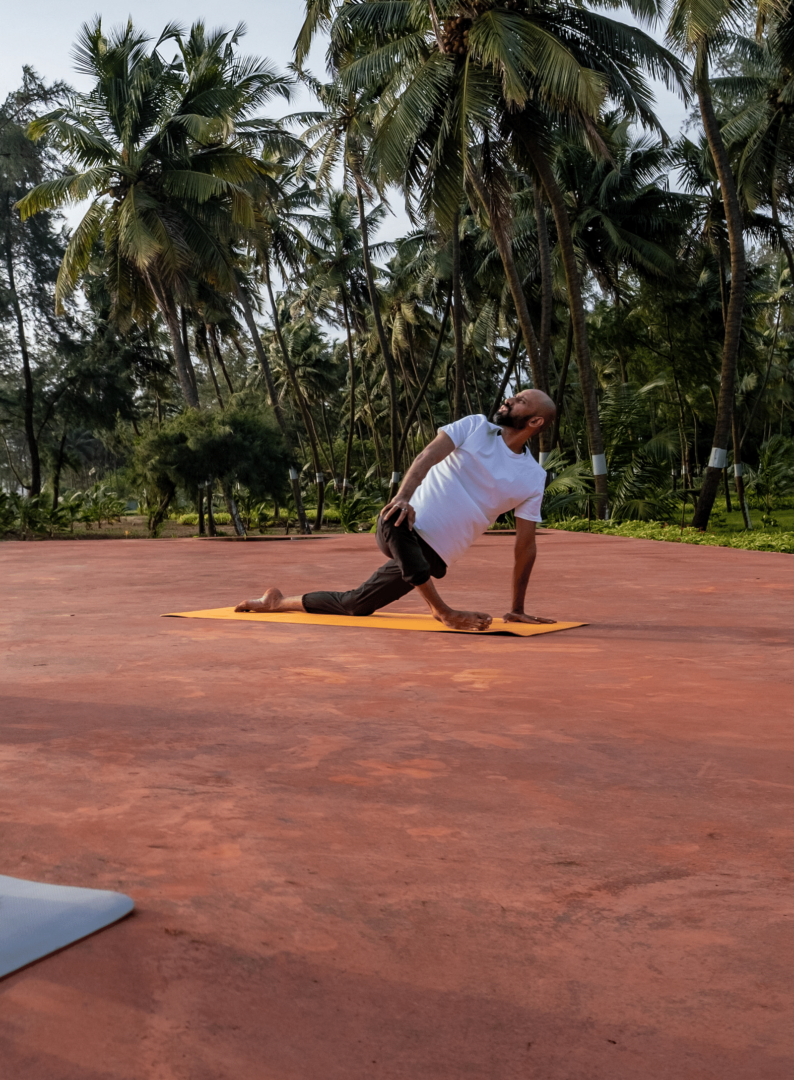 Two people doing yoga in the open.