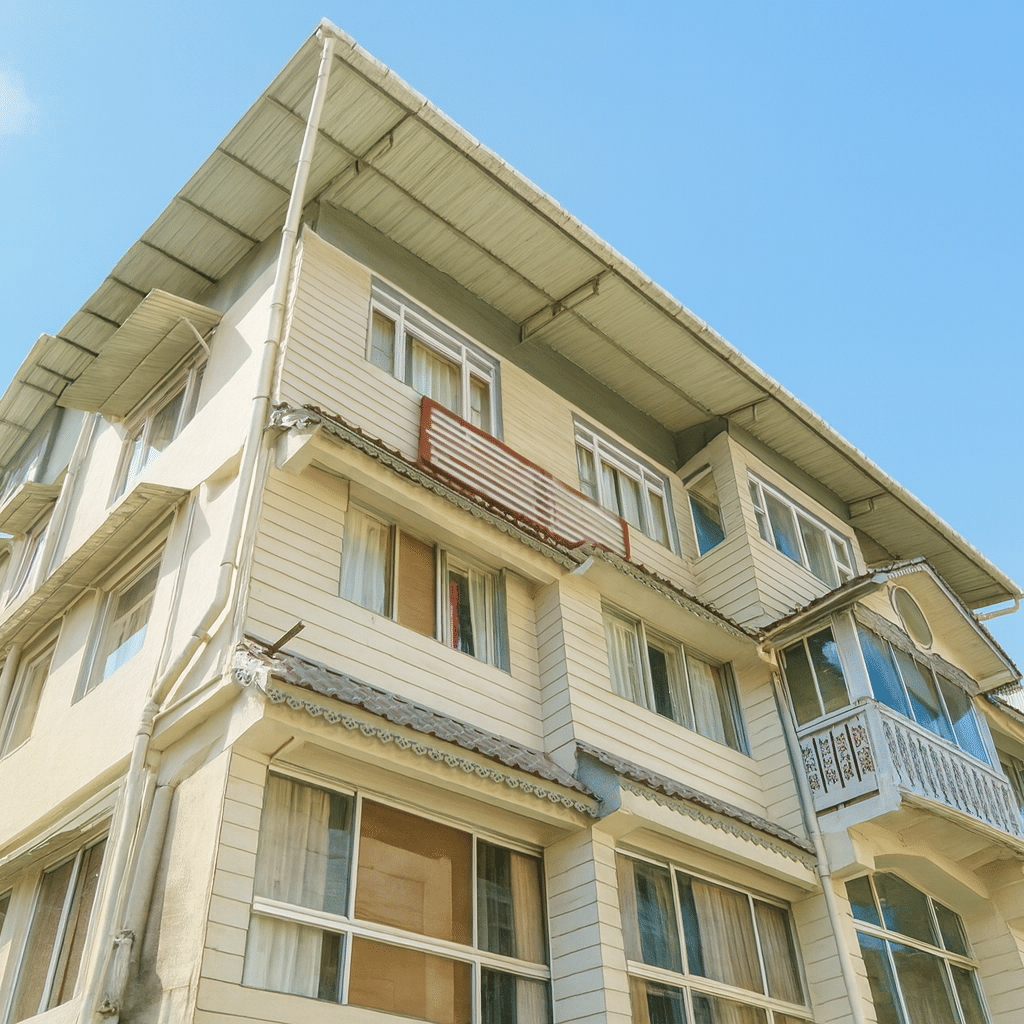 Avianna Seven Seas Hotel in Darjeeling captured in 4K quality during a sunny day, showcasing its elegant facade, clean architecture, and premium exterior lighting under a bright blue sky.