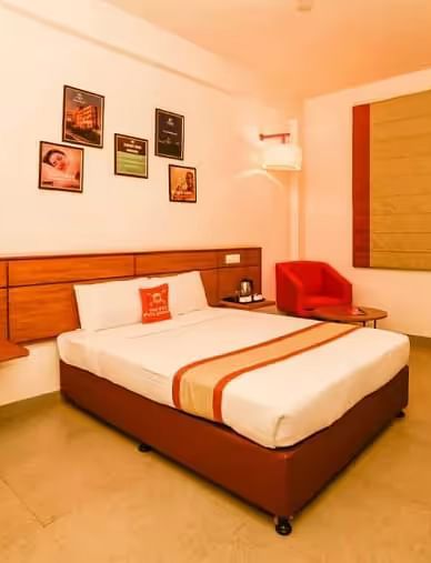 A stylish and cosy hotel room with a king size bed, soft lighting, and contemporary decor - Max Hotel Prayagraj.