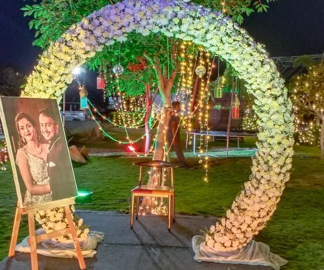 The porch providing entry to lawn and event space that is decorated with lights at GK Hill View Resort.