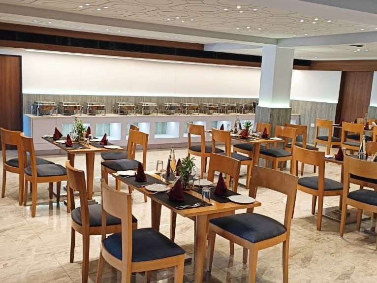 All-day dining restaurant at Lords Eco Inn Dahej offering a welcoming ambience with wooden décor.