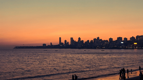 Shot of Marine drive overlooking the Arabian Sea during sunset with buildings in vicinity.