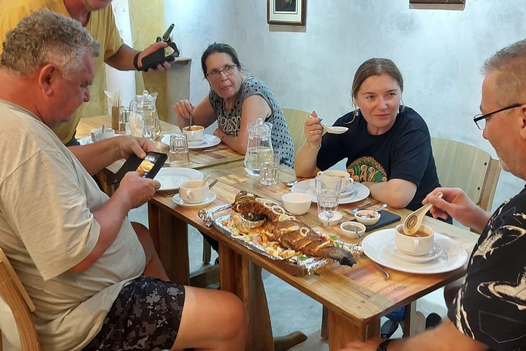 Dining-  table conversation among a group of four.