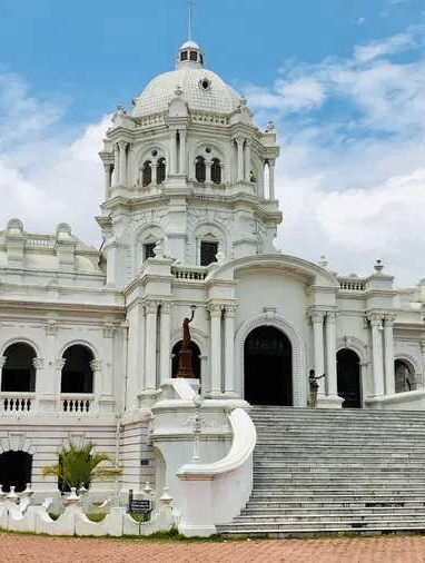 A wide shot of two-story white Ujjayanta Palace in Agartala.