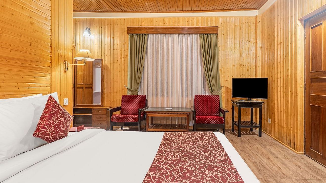 Side view of a room with bed and siting area at Summit Tashi Ghang Heritage Resort, Pelling