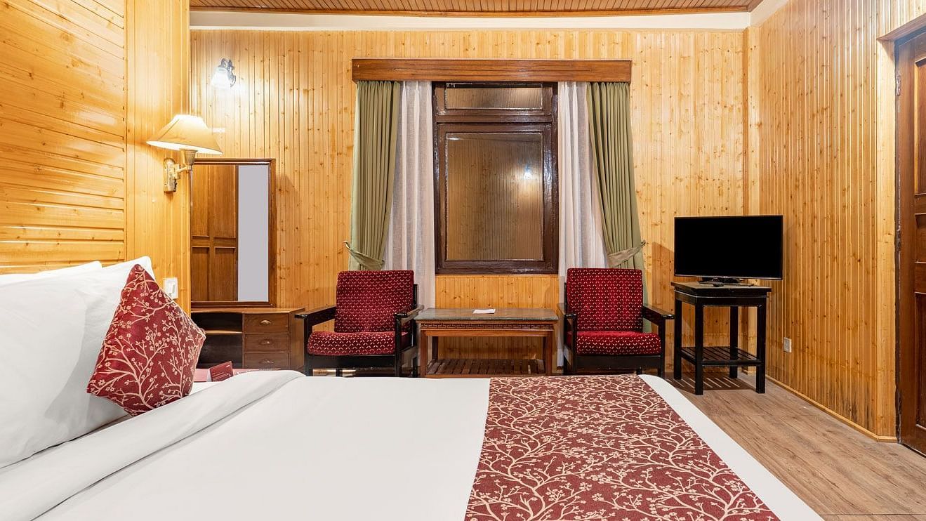 Side view of a room with bed and television in the corner at at Summit Tashi Ghang Heritage Resort, Pelling