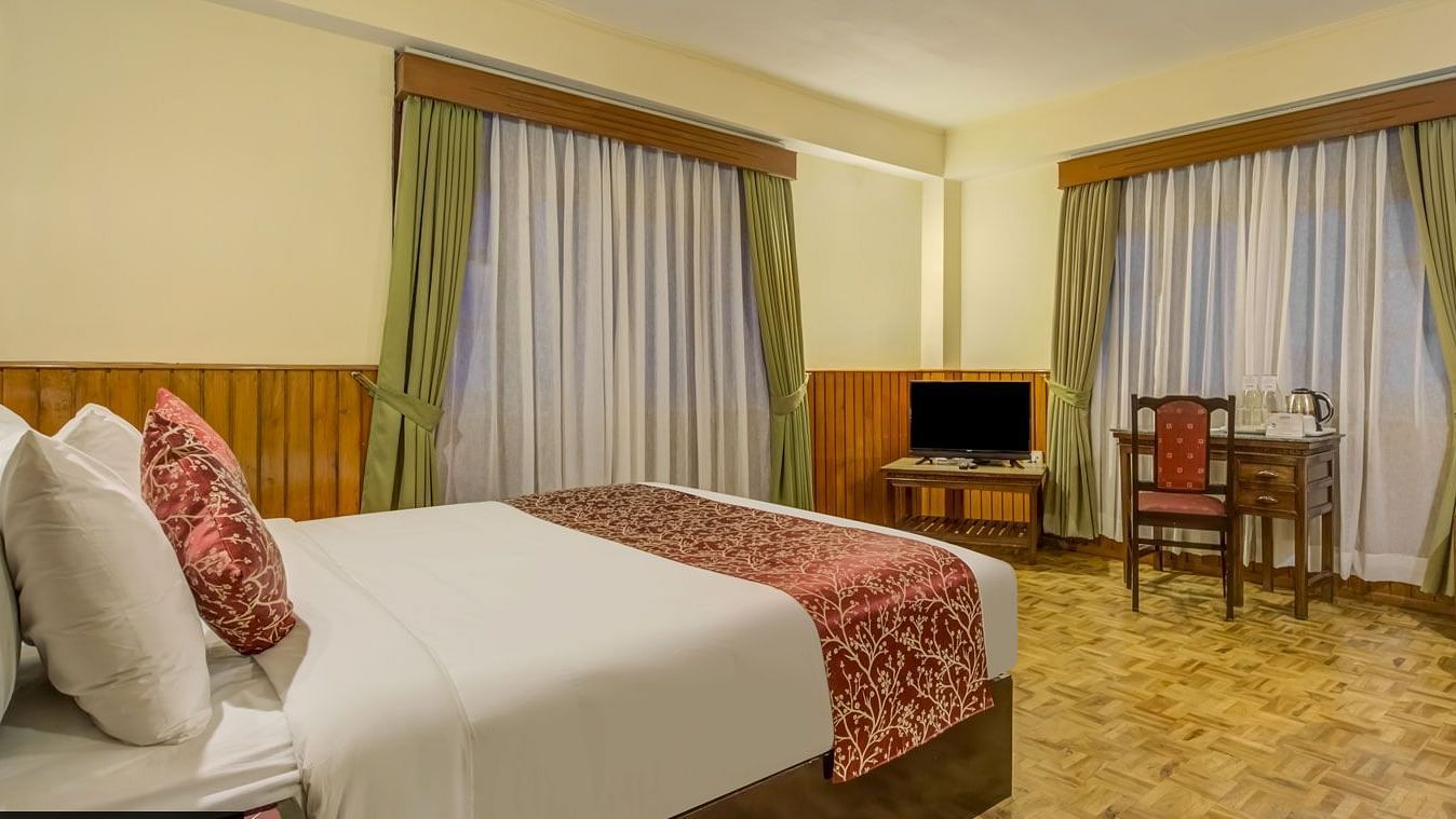 Image of a room with bed and windows on two sides of the room at Summit Tashi Ghang Heritage Resort, Pelling